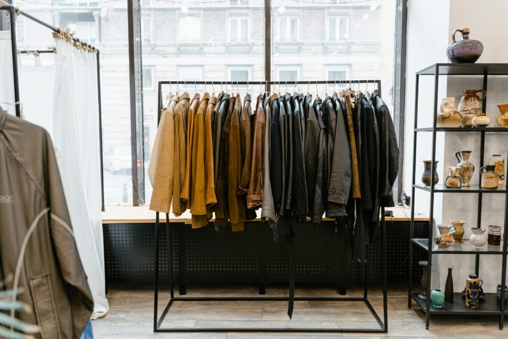 Stylish clothing store interior with jackets on a rack, creating a modern boutique atmosphere.